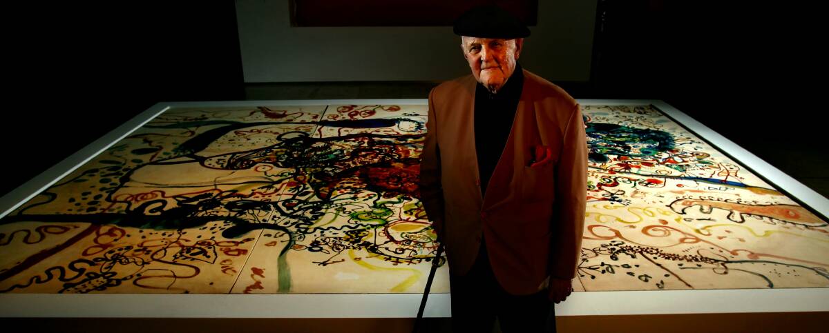 Artist John Olsen with his prized work, The Sea sun of 5 bells, part of Newcastle's collection.