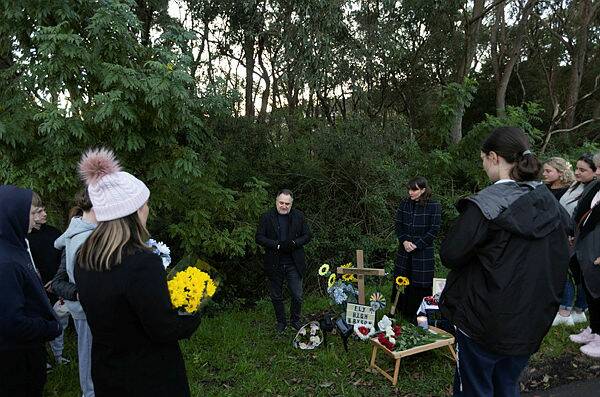 Family and friends of Bryson Dimovski gather at a roadside vigil for the 12 month anniversary of the teenager's death. Pictures by Jonathan Carroll.