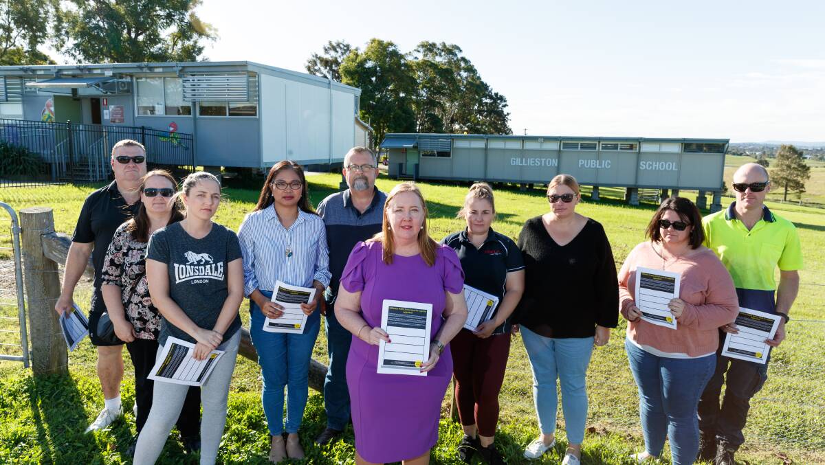 Jenny Aitchison MP and Gillieston Public School parents in 2022 with a petition calling on the government to address the infrastructure issues at the school. Picture by Max Mason-Hubers