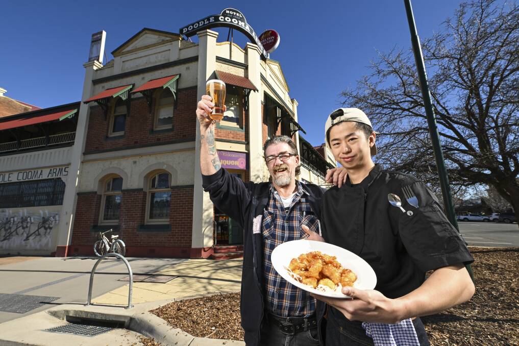 Bar manager Darryn Alcorn and Chef David Jenyu celebrate the reopening of the Doodle Cooma Arms Hotel at Henty giving the community a local pub again. Picture by Mark Jesser