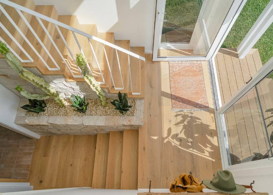 The original green concrete stairwell was transformed with engineered oak timber flooring and stone features. Picture supplied