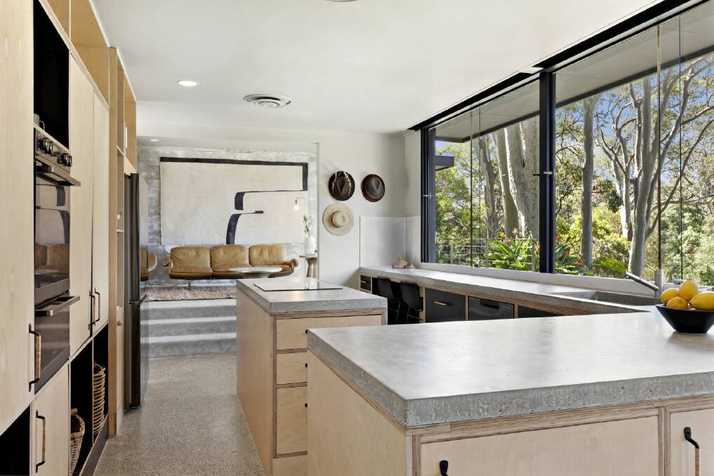 The kitchen has brushed concrete benchtops and ply doors with ornate hand-crafted handles. Picture supplied