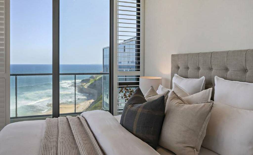 The view from one of the bedrooms looks across Newcastle Beach, with balcony access that takes in a view of Christ Church Cathedral. Picture supplied
