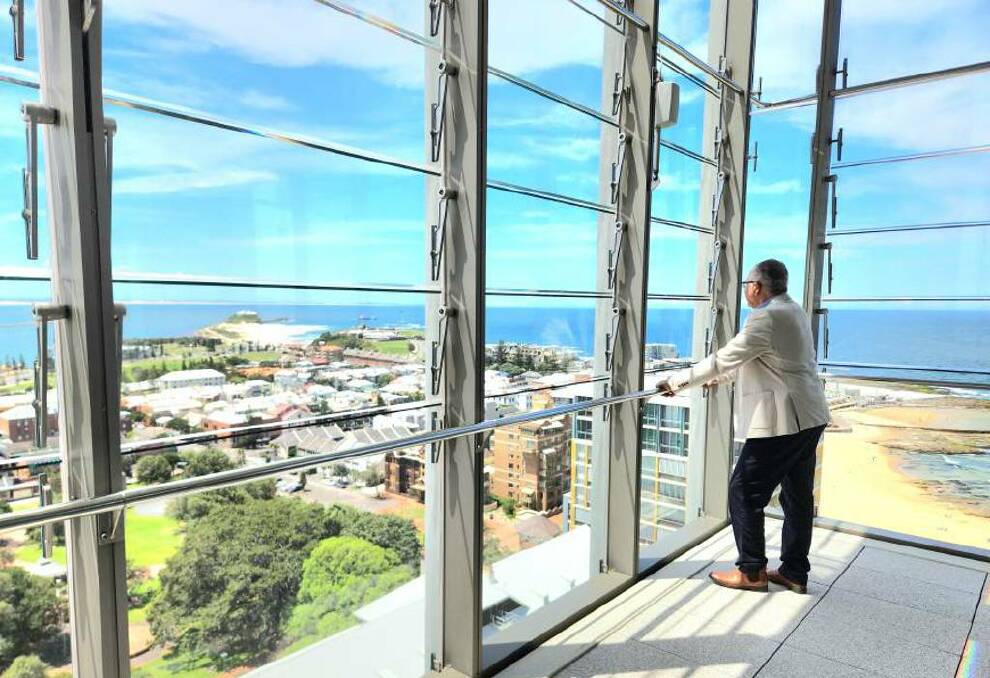 Colliers Residential Newcastle listing agent Anthony Merlo takes in the view from the 16th floor of the penthouse apartment that he sold for more than $8.3 million. Picture supplied