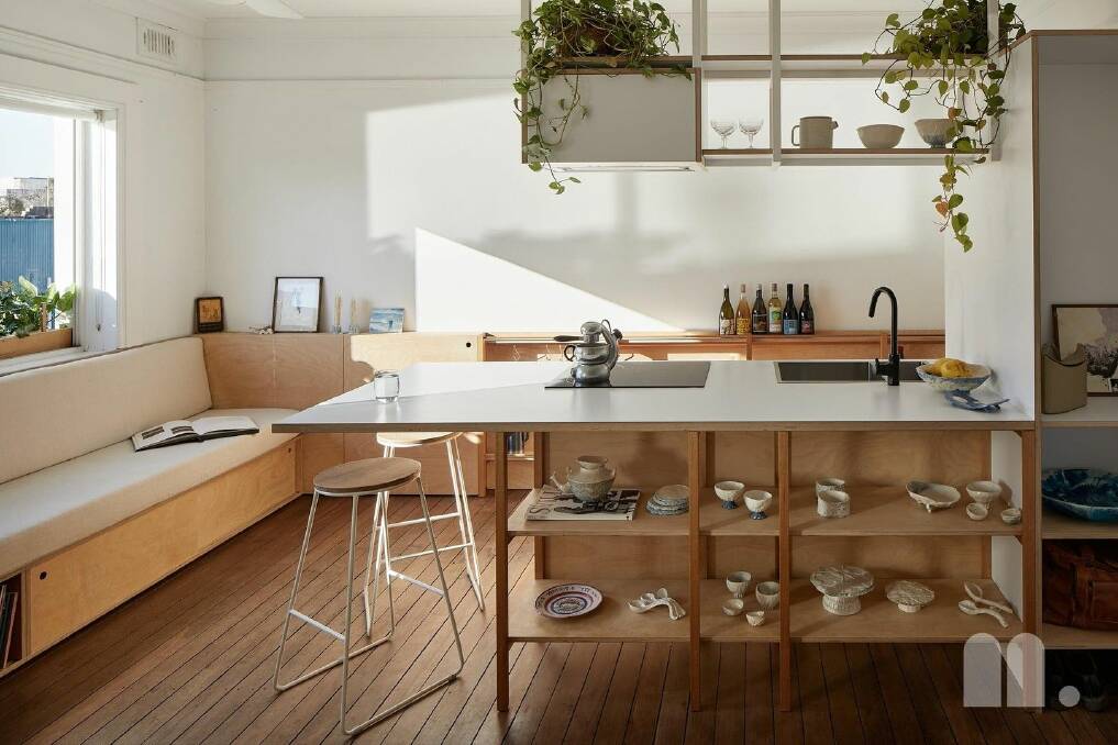 The property features a clever redesign with the kitchen placed at the centre of the apartment, with built-in seating and storage used to maximise the space. Pictures Alex McIntyre