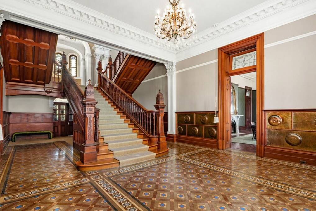 The ornate staircase in the grand entryway was carved in Germany using Australian cedar and rosewood. Picture supplied