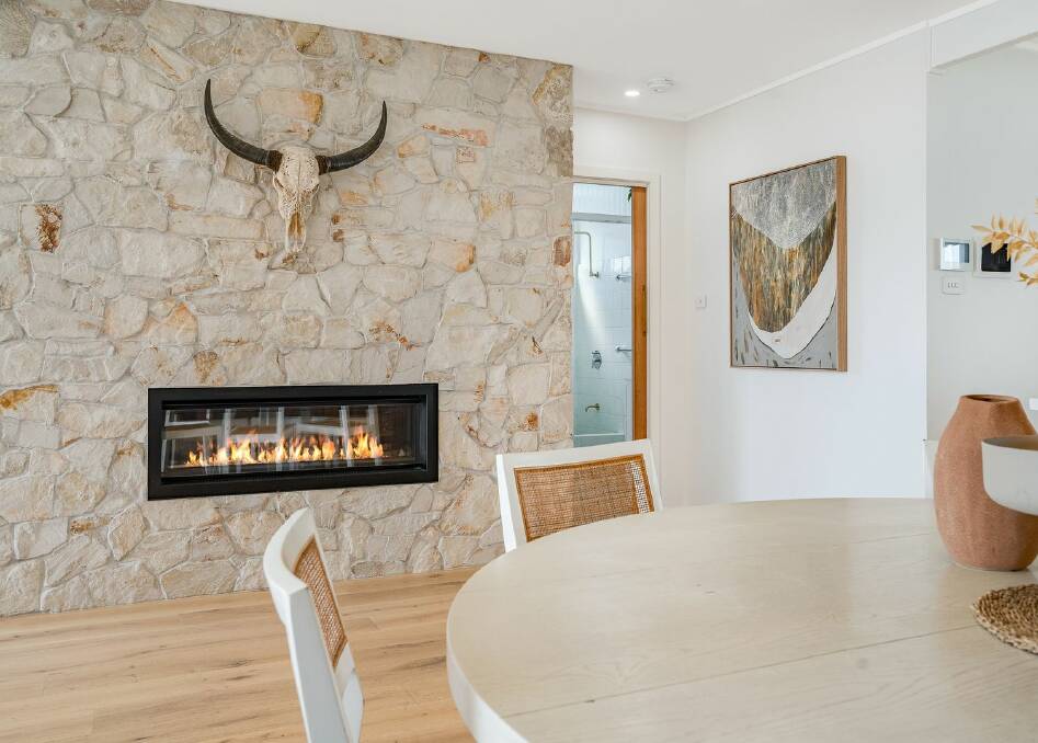 The gas fireplace and stone wall feature is one of the home's new additions. Picture supplied
