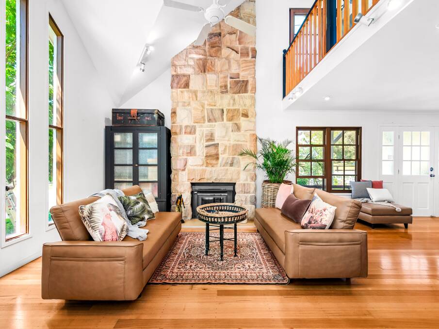 Features of the home include high cathedral ceilings, timber floorboards and a sandstone fireplace. Picture supplied