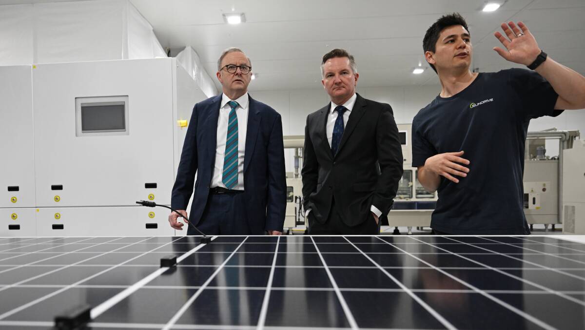 Prime MInister Anthony Albanese (left) and Minister for Climate Change and Energy, Chris Bowen (centre) during a visit to Australias first mass production facility for solar panels Sundrive in November. (AAP Image/Dean Lewins) 