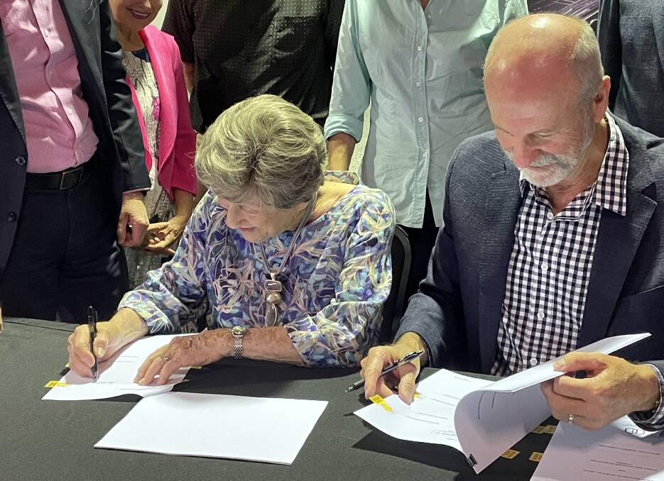 Joy McKean and David Kirkpatrick, Slim Dusty's widow and son, sign the final papers to transfer ownership of the Slim Dusty Centre to Kempsey Shire Council. Picture by Ellie Chamberlain
