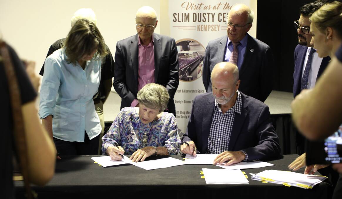 Slim Dusty's widow Joy Mckean and son David Kirkpatrick sign papers on Thursday, December 15 2022, to hand over ownership of the Slim Dusty Centre to Kempsey Shire Council. Picture by Annabelle Sneddon