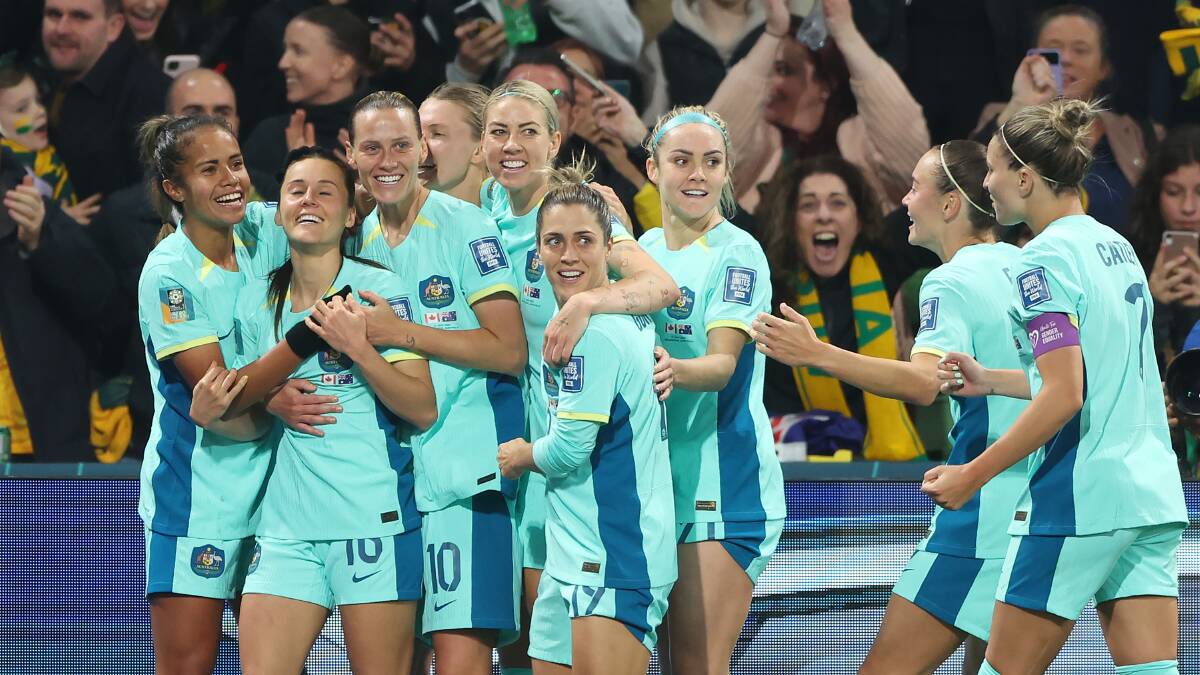 The Matildas get around their teammate Hayley Raso after scoring a goal. Picture - Getty Images