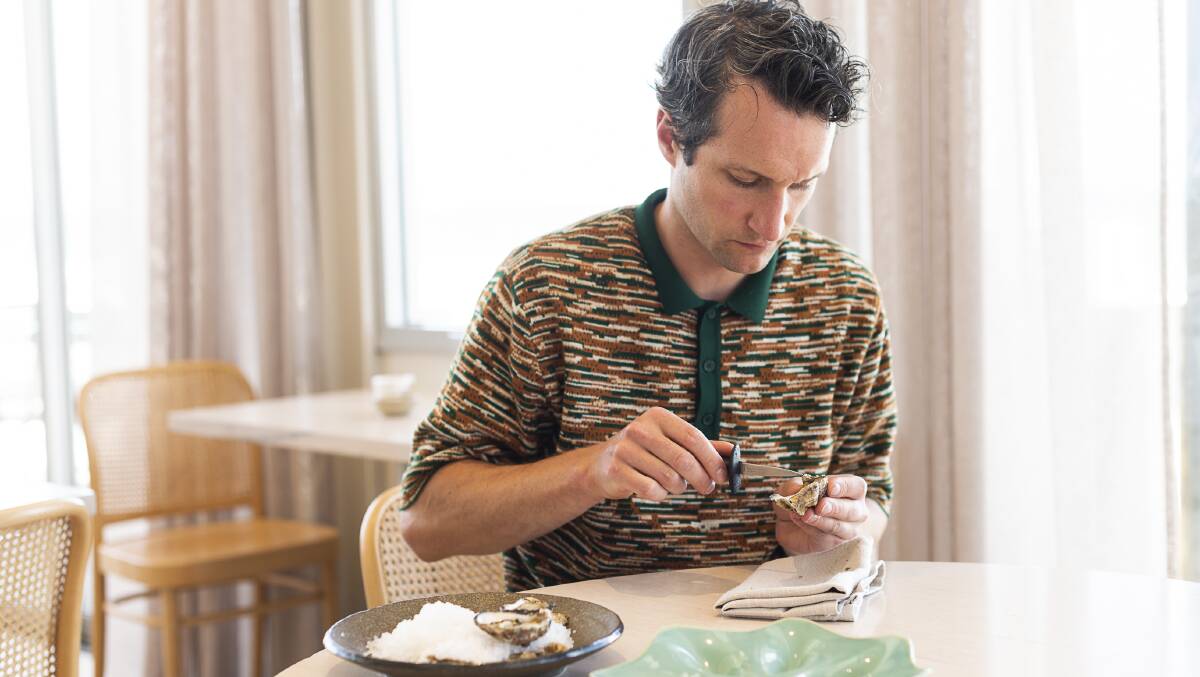 Pipi's Jordan Clay shucking oysters in his Albert Park restaurant. Picture by Carmen Zammit