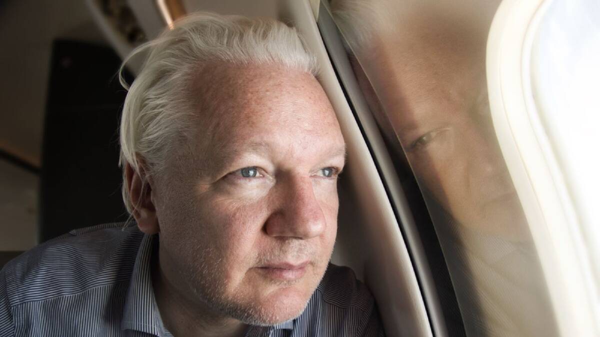 Julian Assange looks out the plane window as the flight enters US airspace. Picture WikiLeaks/X