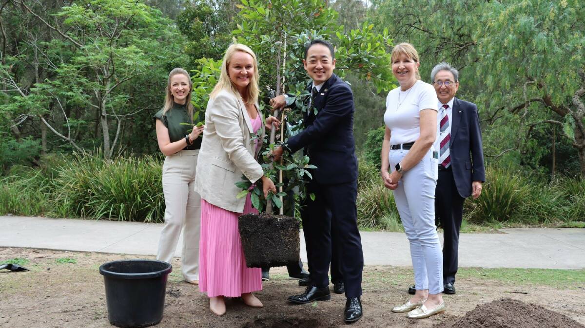 From left to right: Councillor Elizabeth Adamczyk, Newcastle Lord Mayor Nuatali Nelmes, Ube Mayor Keiji Shinozaki, Councillor Katrina Wark and a member of the Ube City delegation plant a tree at Blackbutt Reserve. Picture supplied 