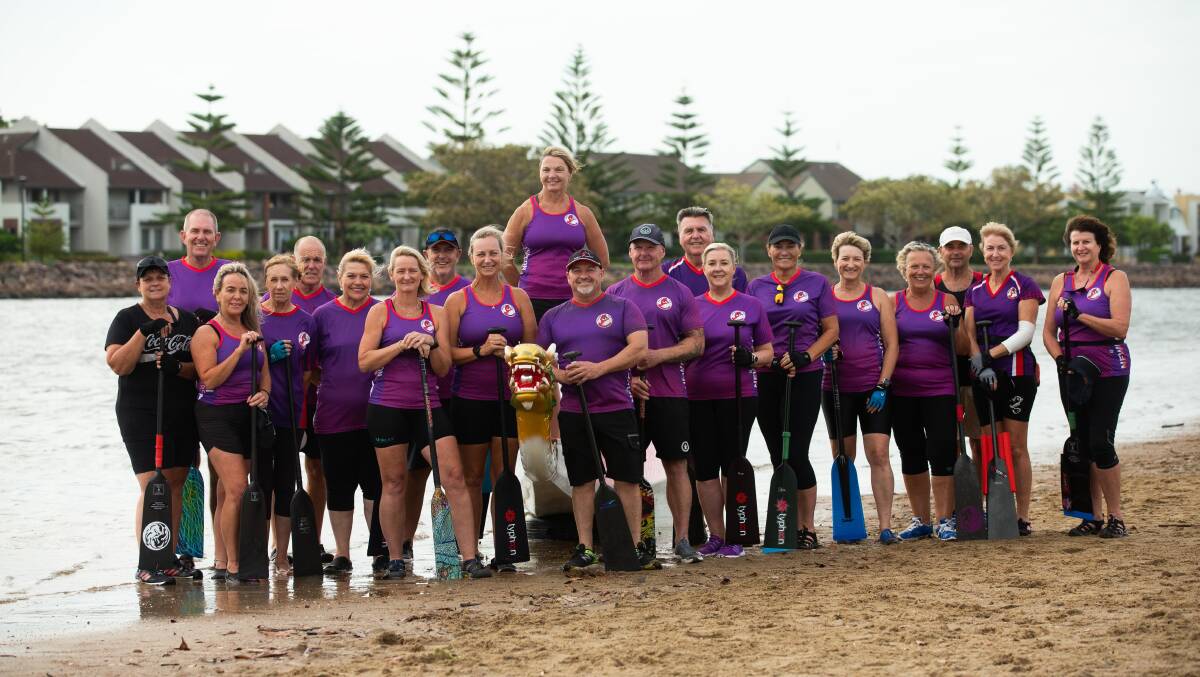 Newcastle Hunter dragon boaters say their success is a team effort. International competitors Catherine Vandine, Amanda Mitchell, Clint Lee, John Morrison are seventh from left. Picture by Jonathan Carroll