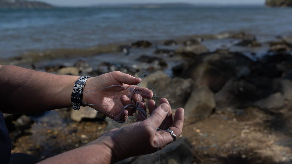 Fishing line, like what Tania Rossiter holds here, can strangle and lacerate turtles. Picture by Marina Neil
