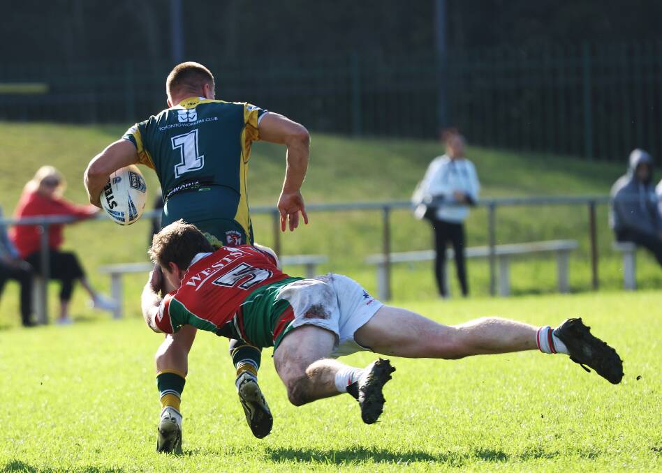 Hayden Sutton is tackled. Action in the Newcastle rugby league clash between Wests and Macquarie. Picture by Peter Lorimer