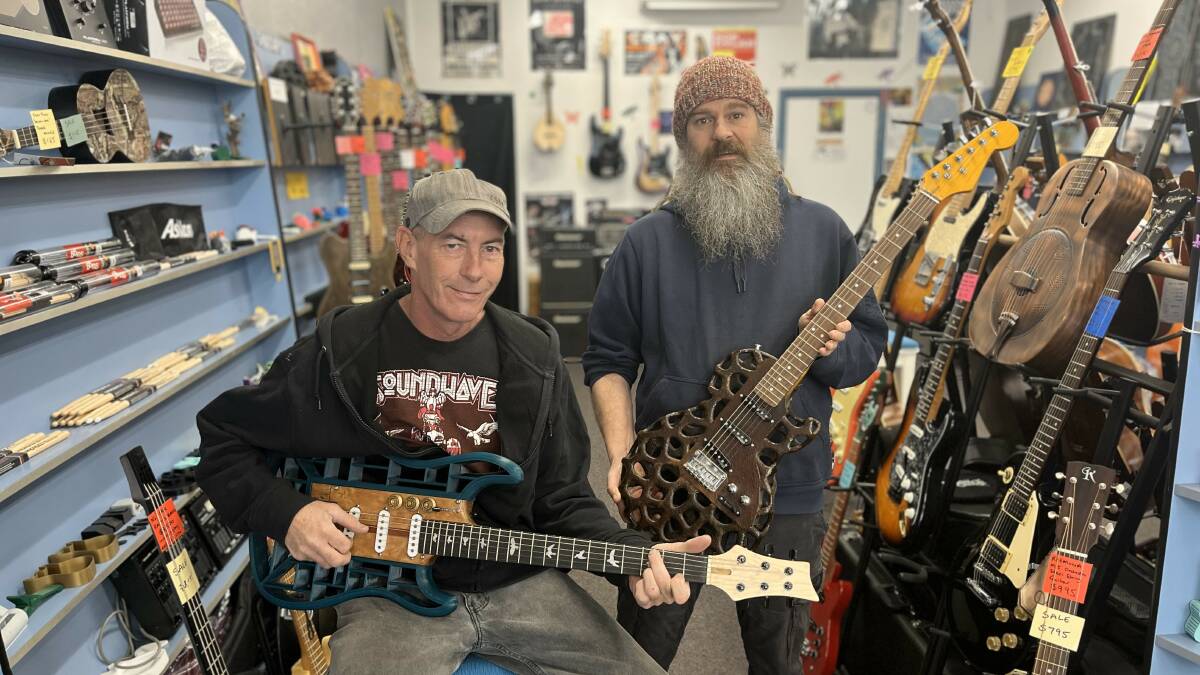 Rob Harlow and Nate Hughston with two custom 3D printed guitars. Picture by James Parker.