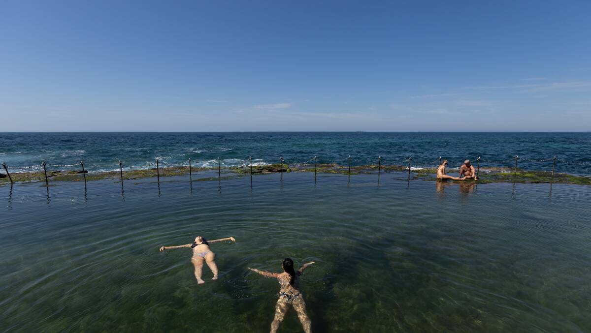 Brisbane tourists, Sarah Bispham and Zess Thomas, enjoying their swim at the Bogey Hole. Picture Jonathan Carroll