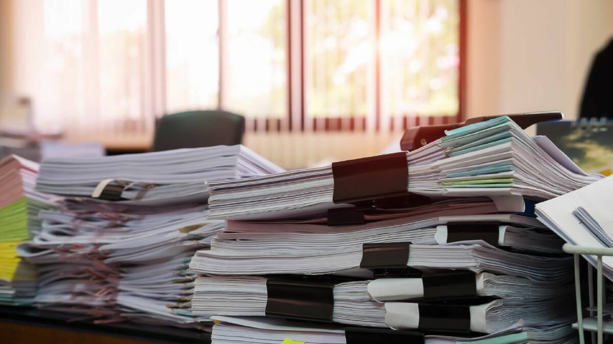 Generic picture of files on a desk. Picture by Canva. 