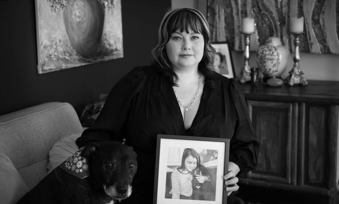 Rebekah Porter with her dog and a photo of her daughter Biddy. Picture supplied 