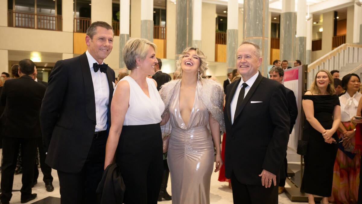 Environment Minister Tanya Plibersek, second from left, with her husband Michael Coutts-Trotter, left, and NDIS Bill Shorten, right, with his daughter Gigi. Picture by Sitthixay Ditthavong
