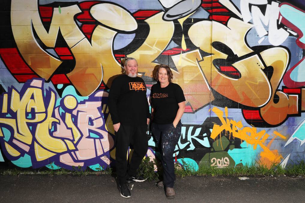 Longtime mural artists Shane Kennedy and Faith Curtis in front of one of their creations in an alleyway off Cleary Street, Hamilton, in August of this year. Picture by Peter Lorimer
