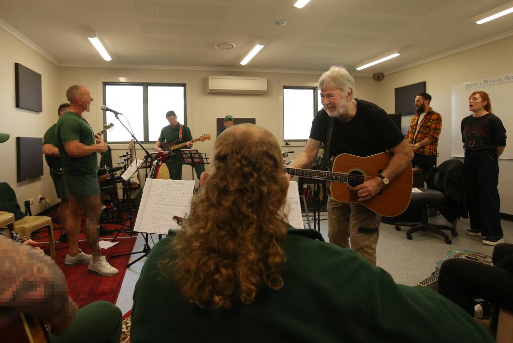 Australian music legend John Schumann leading inmates at Cessnock Correctional Centre in band rehearsal on Tuesday. Picture by Simone De Peak
