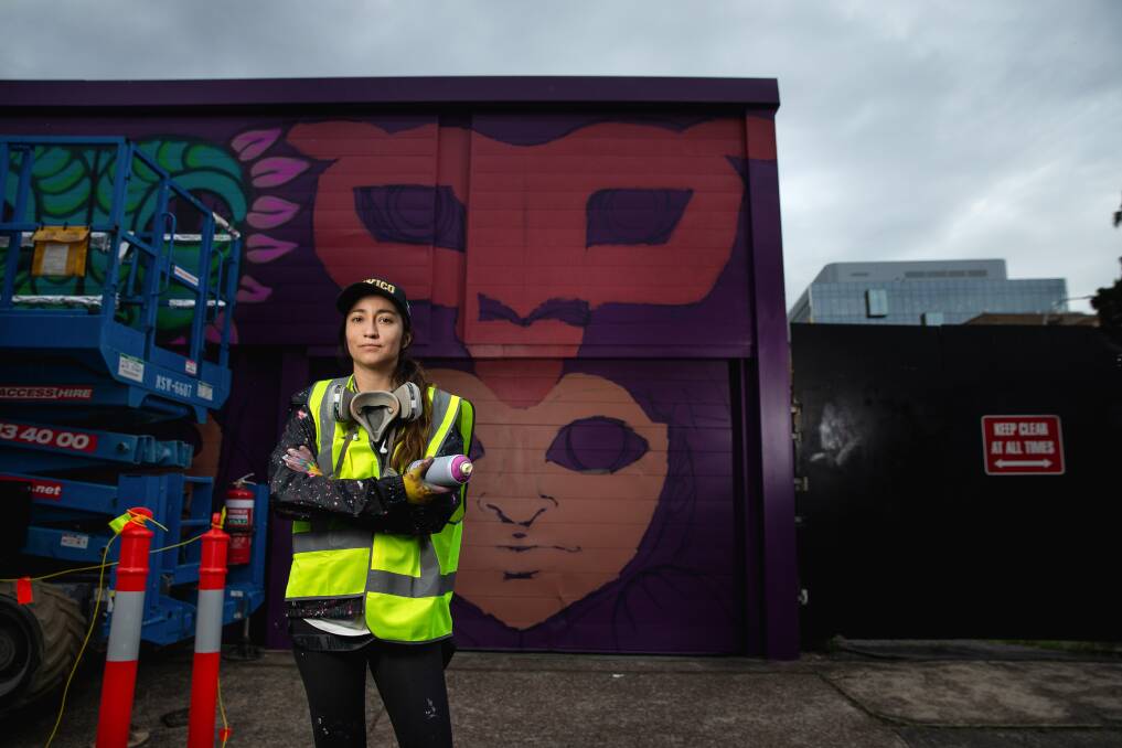 Artist Goya Torres in the early stages of her mural on Gibson Street, Newcastle. Picture by Marina Neil