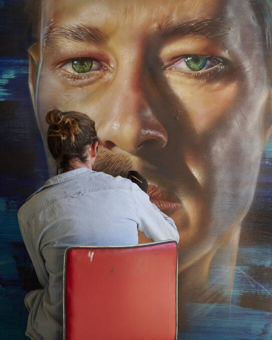 Bigger than life: Adnate working on an image of Daniel Johns that is part of the exhibition in Melbourne.
