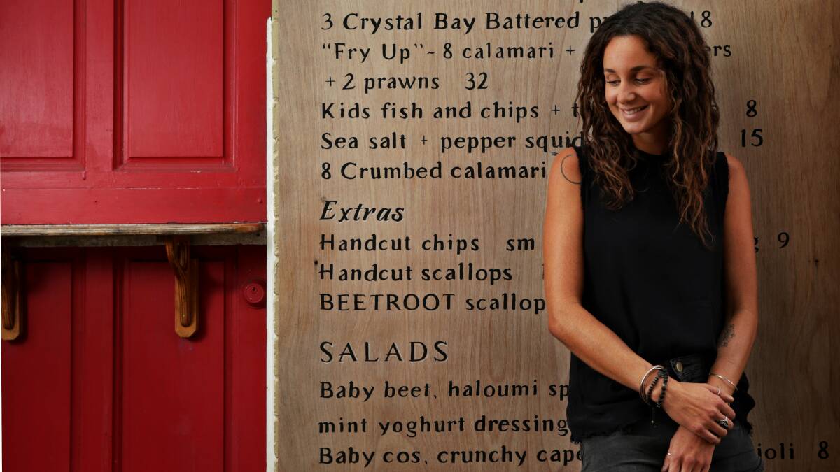Humble foodie: Self-made cook Ashleigh Hays, creator of formysenses food blog, in front of the outdoor menu board at Scotties Fish Cafe. Picture: Simone De Peak