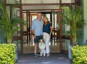 Andrew and Nickey Blades, with their dog Bear, at the front door of The Homestead at Sweetacres Hunter Valley. 