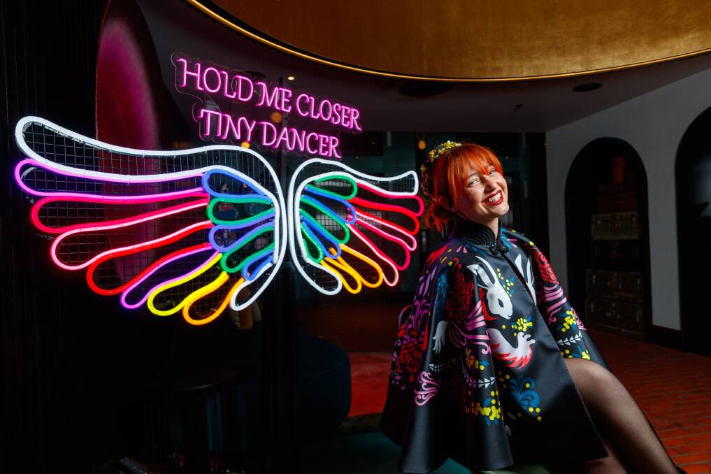 QT Newcastle "director of chaos" Teddi Pascoe posing with the Elton John wings in the hotel lobby. Picture by Max Mason-Hubers