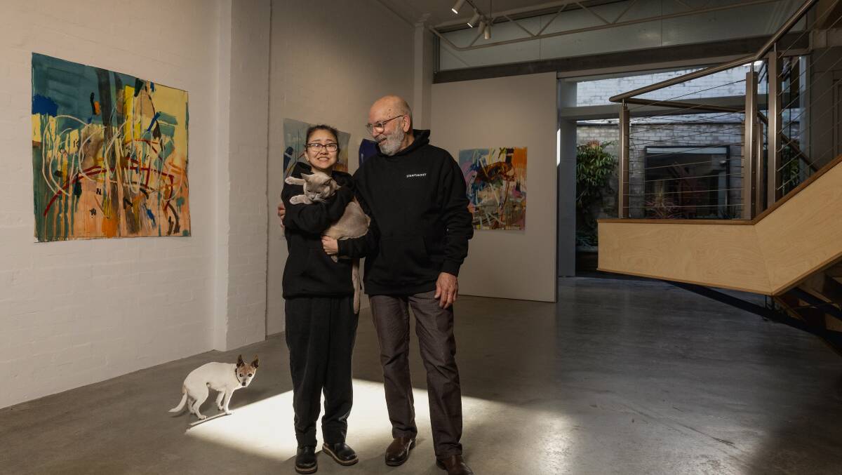 Ahn Wells and Dino Consalvo in Straitjacket with their Burmese cat, Alfie, and dog Odea. Picture by Marina Neil