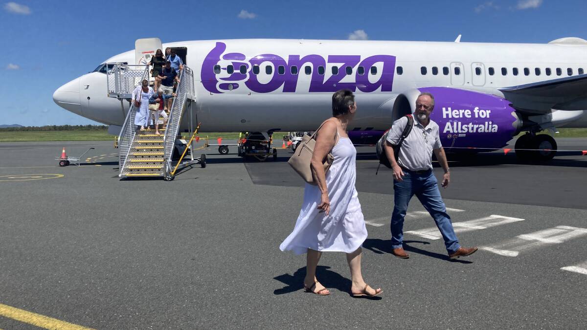 Passengers arrive on the first Bonza flight from Newcastle to Proserpine last week. Picture by Michael Parris 