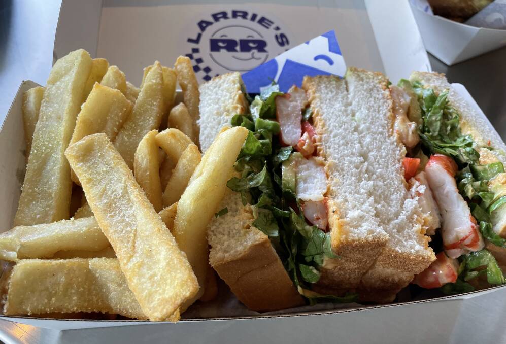 The special chicken salt is the perfect touch on the hot chips at Larrie's at the Beach Hotel in Merewether (pictured with a prawn sandwich). Picture by Jim Kellar