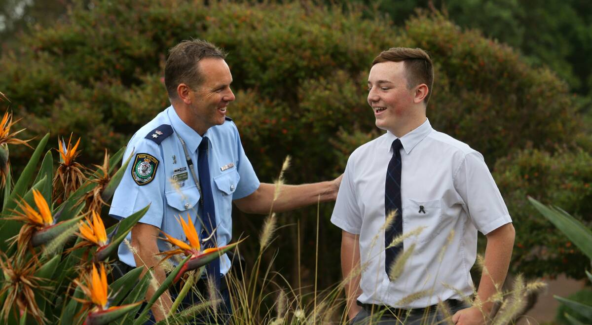TOUCHED: Port Stephens Superintendent Chris Craner thanks Tom Finlay for his poem about police killed in the line of duty. Picture: Jonathan Carroll.
