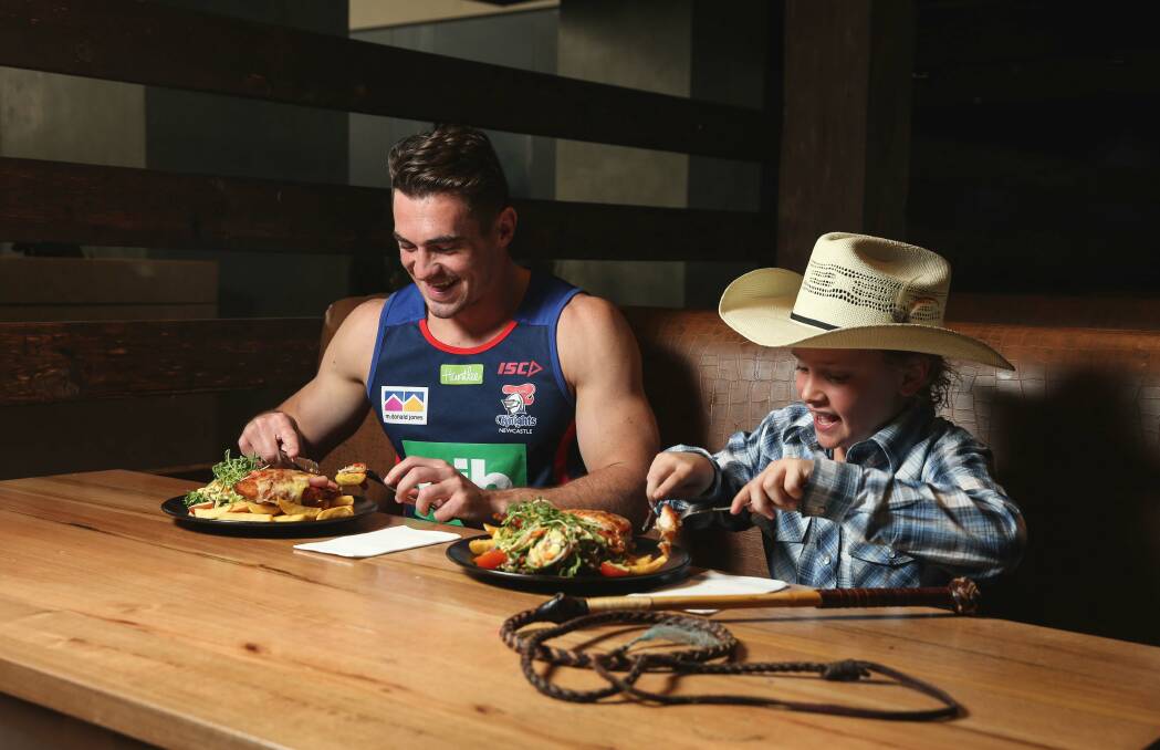 Conor Watson and Ollie Russell tuck into a chicken parmigiana at Wests Mayfield. 