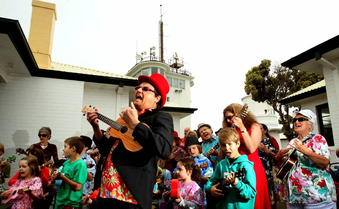 FUN: Mark Jackson leads a flash mob at Nobby's lighthouse in the lead-up to the first Newkulele Festival in 2012. Picture: Simone De Peak