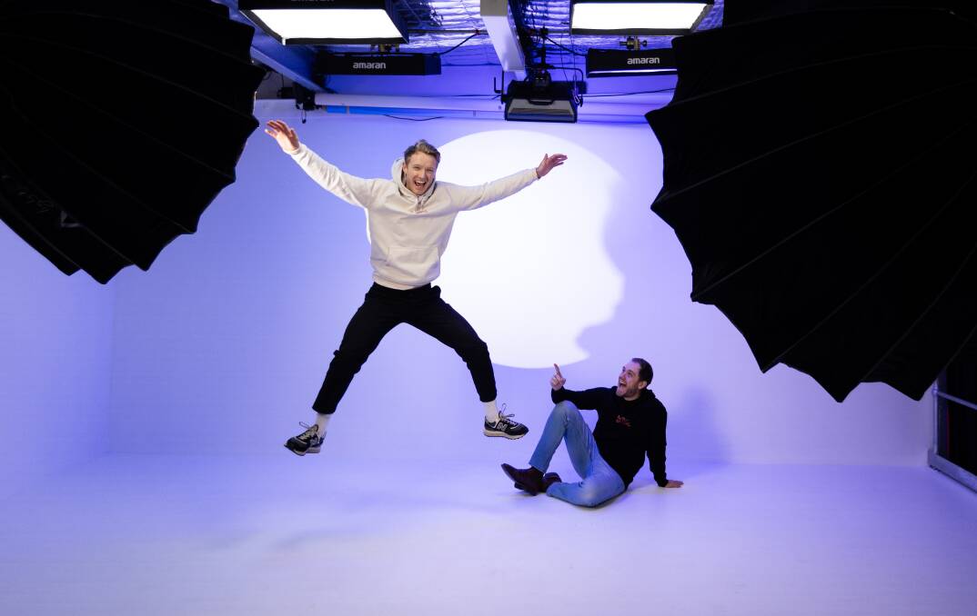 Toby Tull and Joel Wagner making a splash in Newy Studio's photo lab. Picture by Jonathan Carroll