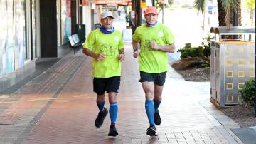 Wayne Curran and Pat Farmer on their epic 494-kilometre run to raise awareness about foster care. Picture by Scott Calvin  