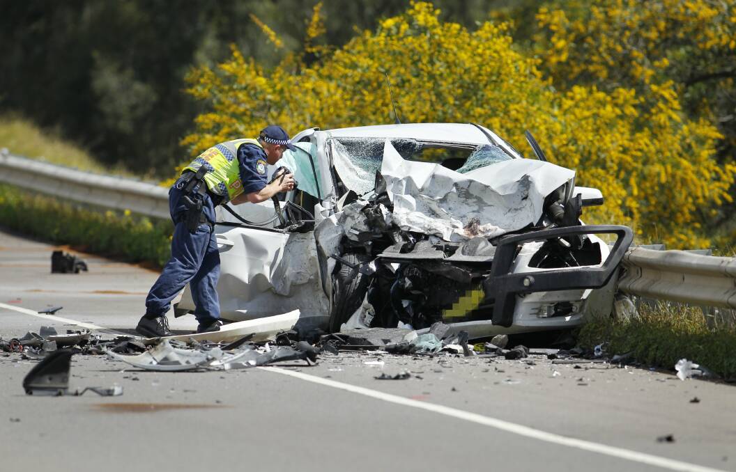 A fatal car accident on the New England Highway near Singleton in September 2014.  A 72 year old man died and a 30 year old woman was flown to John Hunter Hospital with injuries. Picture: Max Mason-Hubers  