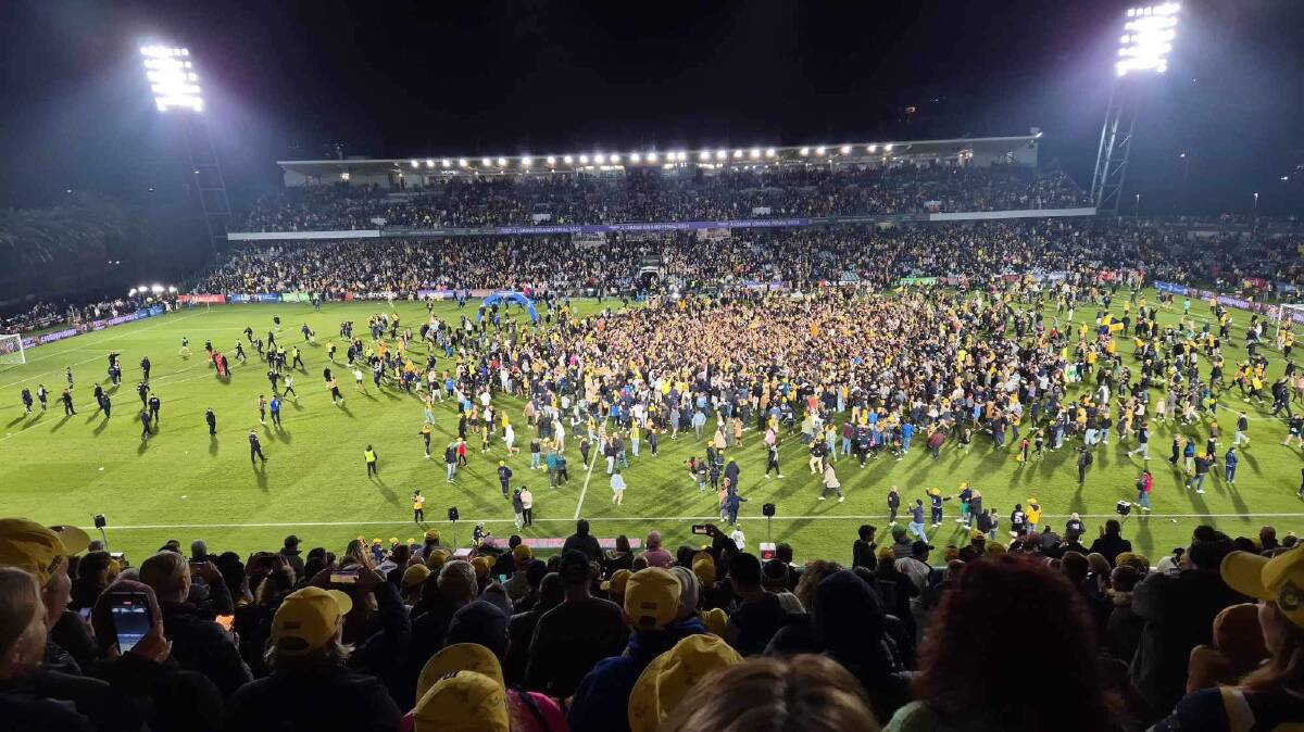 Mariners fans on the pitch after the game. 