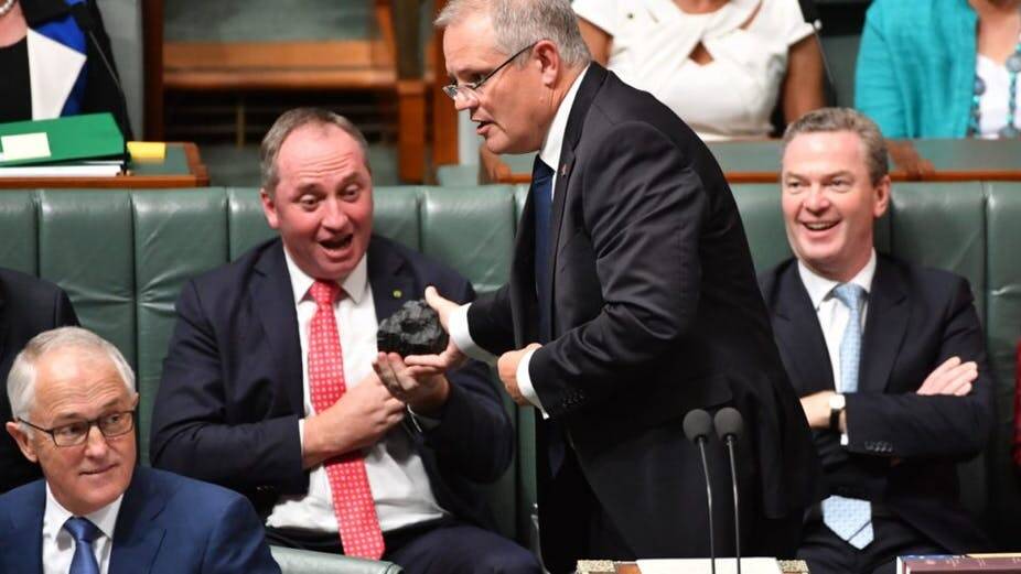  COMBUSTIBLES: Scott Morrison as treasurer in 2017 with a lump of Hunter Valley coal in his hands, before being reminded by the Speaker of the rules forbidding debating 'props' being brought into parliament.