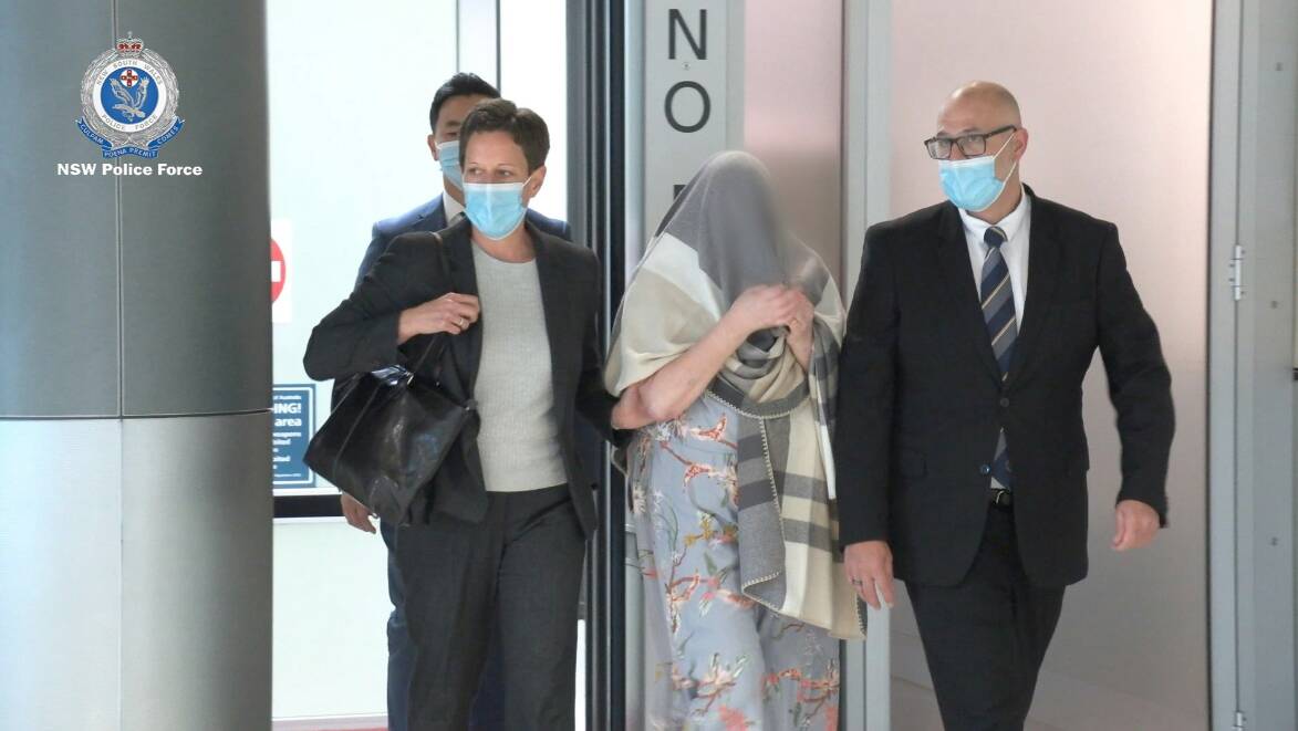 Ellen Rachel Craig (centre) being escorted from Sydney Airport on May 12, 2022 by Strike Force Bertrand detectives. Picture by NSW Police