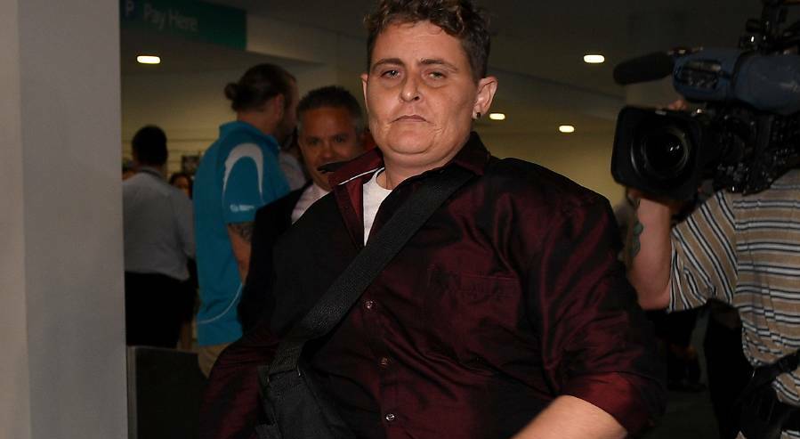 Renae Lawrence on the run from the media at Newcastle Airport on Thursday. Picture: AAP/Dan Himbrechts