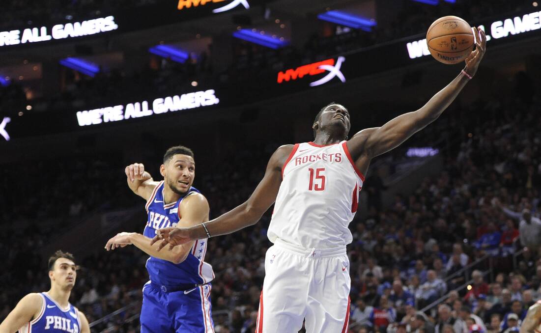 EFFORT: Houston Rockets' Clint Capela (15) reaches for the ball as Philadelphia 76ers' Ben Simmons does his best to spoil. Picture: AP