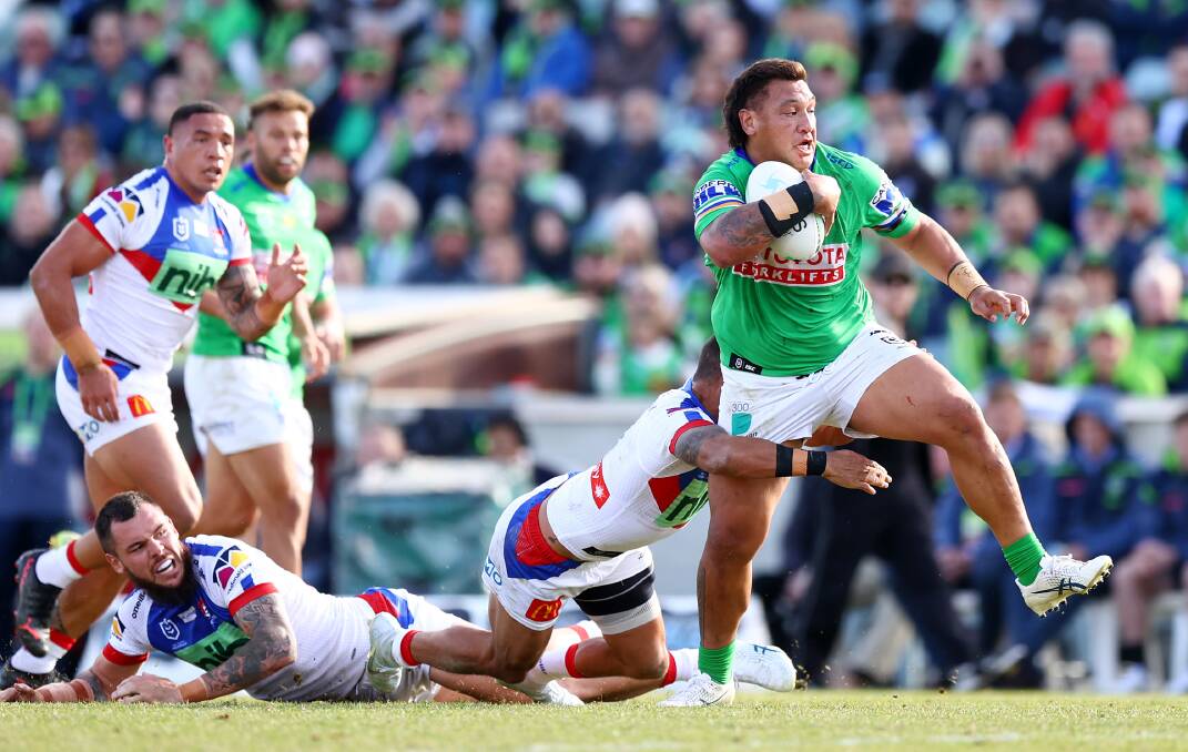 WRECKING BALL: Canberra's Josh Papalii charges through the Newcastle ruck. Picture: Getty Images