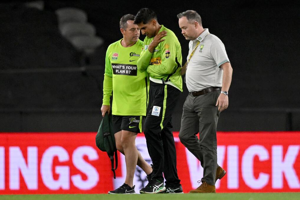 Jason Sangha being helped from Marvel Stadium. Picture Getty Images